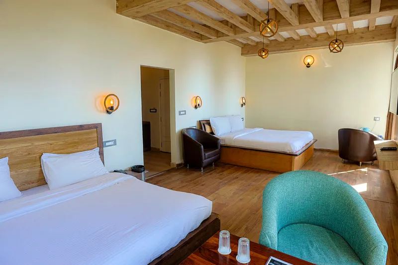 Cozy interior bedroom of Family Twin Room — Ground Floor Orchard Access for Kids & Parents at Whispering Pines Resort Mukteshwar, Uttarakhand